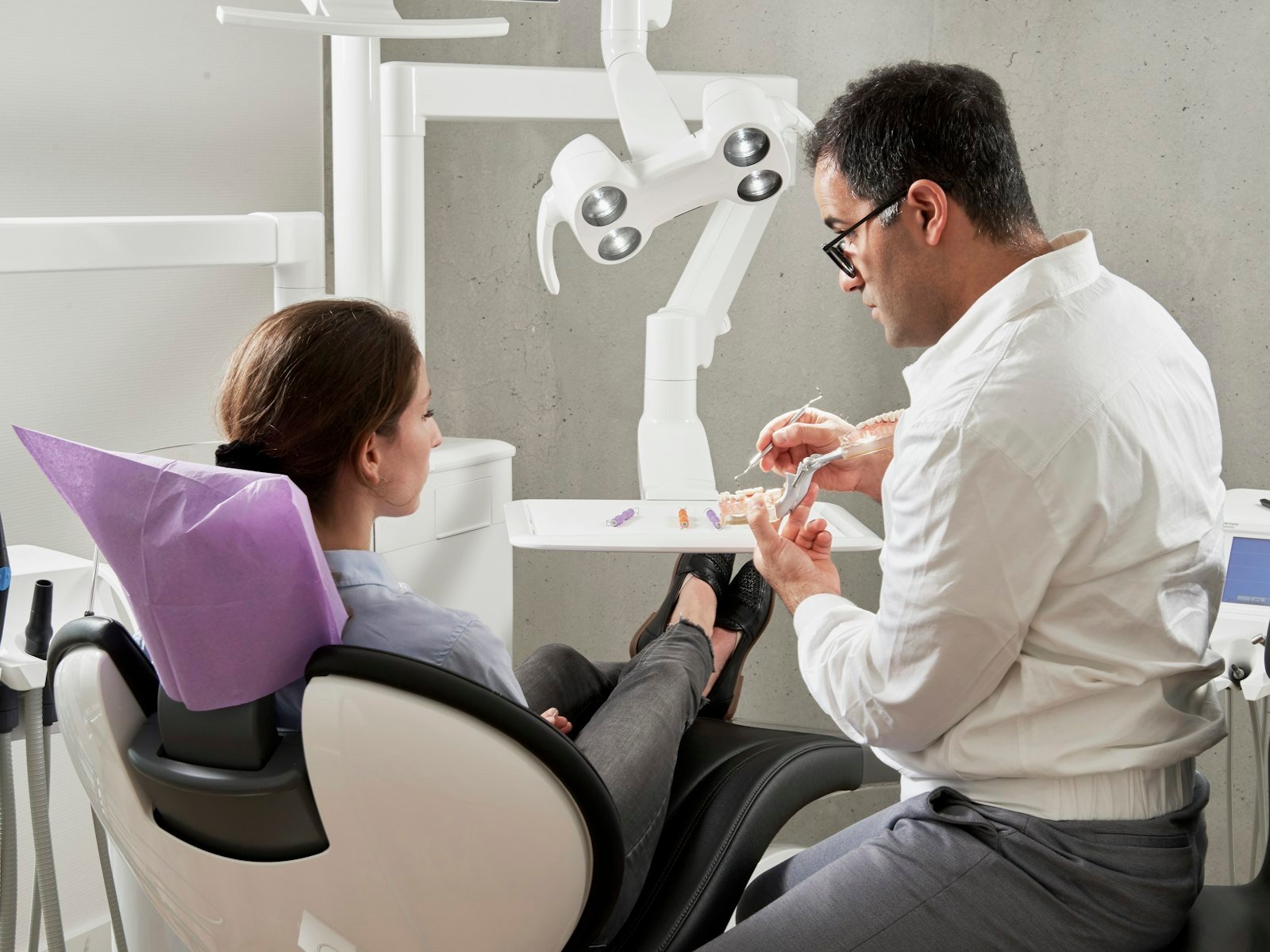 A dentist talking with a patient during a consultation