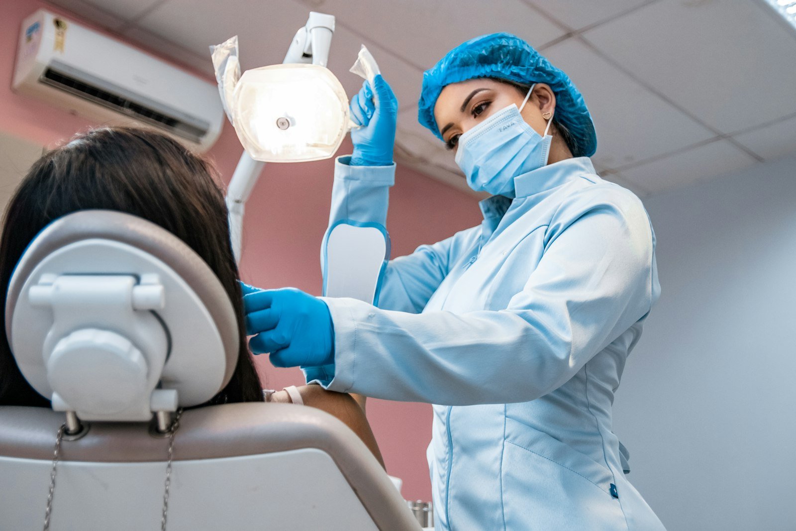 A precise dental procedure carried out under clinic lighting